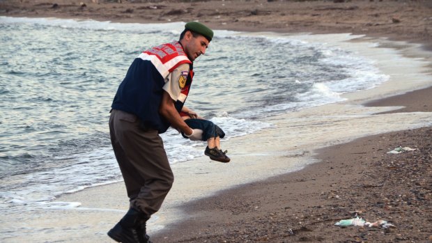 A police officer carries three-year-old Aylan Kurdi after he drowned near the Turkish resort of Bodrum.