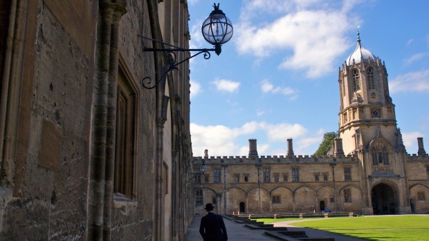 An attendant on the grounds of Oxford University where some current students have performed poorly.