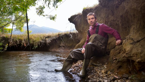 Wetlands ecologist Joe Greet in a waterway near Woori Yallock, where the banks have eroded due to a lack of vegetation.