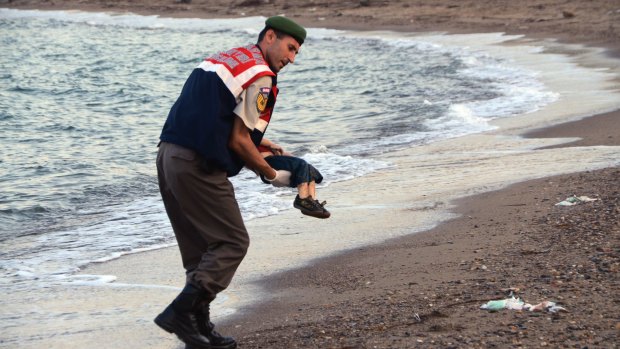 A police officer carries three-year-old Aylan Kurdi after he drowned near the Turkish resort of Bodrum.