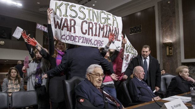 Protesters interrupt former US secretary of state Henry Kissinger.