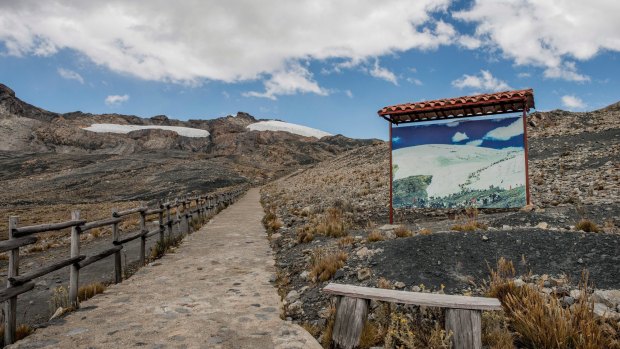 A 30-year-old photograph taken from a nearby location is placed on the path to the Pastoruri glacier in Ancash, Peru, showing how far the ice has retreated.