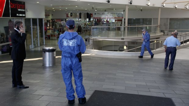 Police investigate a shopping centre in Auburn.