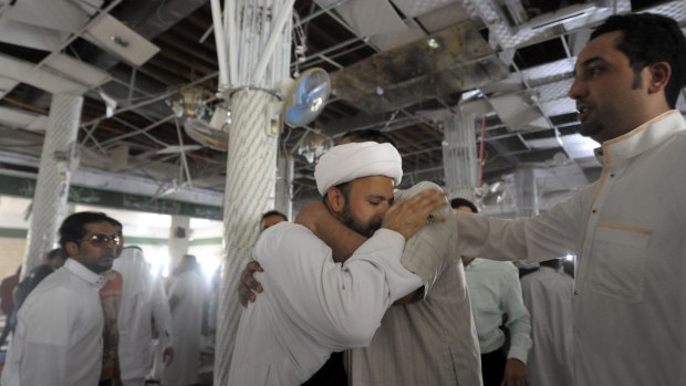 A Saudi man reacts following the suicide bomb blast inside a al-Qadeeh mosque.