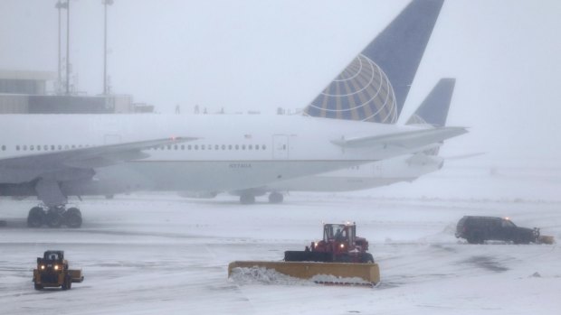 Snowplows work to keep the grounds clear at Newark Liberty International Airport in Newark, New Jersey. 