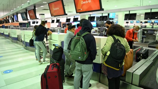 Passengers check in for the first bubble flight.