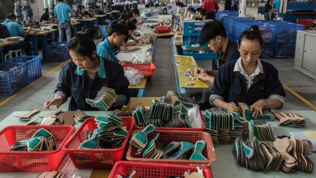 Workers on the assembly line at the Huajian shoe factory in Dongguan, China, where heels are produced for Ivanka Trump's line of shoes.