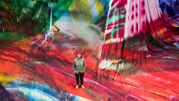 The artist spent 10 days painting 8250 square metres of fabric draped in the Carriageworks foyer with a three-metre spray gun.