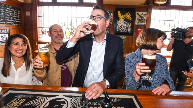 Premier Daniel Andrews enjoys a beer with Paul and Natasha Holgate at the Holgate Brewhouse in Woodend. 
