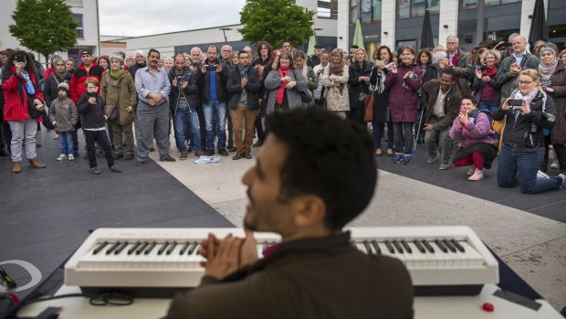 Ayham al-Ahmad performs at a fundraiser in Ingelheim, Germany, in May.