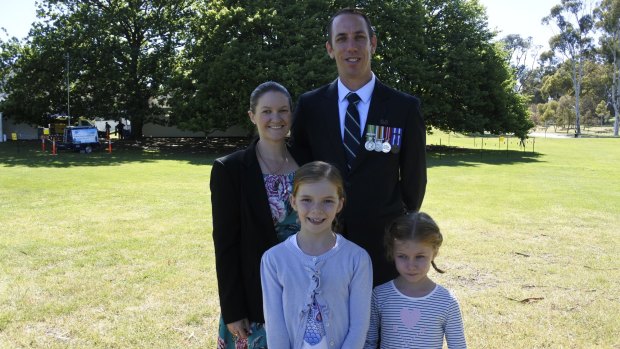 Townsville couple Caetlin and Simon Watch with their daughters Emily, eight, and Hannah, six, took time to reflect at the Remembrance Day ceremony.