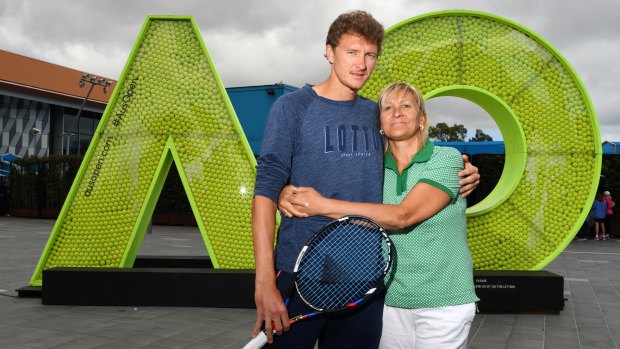 Denis Istomin gives his mother and coach Klaudiya a hug after his Australian Open heroics.