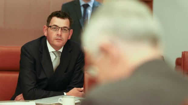Victorian Premier Daniel Andrews listens as Prime Minister Malcolm Turnbull addresses the Council of Australian Governments meeting.