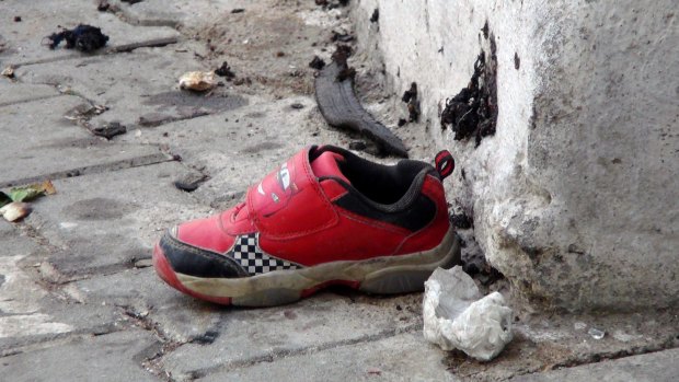 The shoe of a young victim and a piece of metal lay near the scene just hours after Saturday's bomb attack in Gaziantep, southeastern Turkey, early on Sunday.