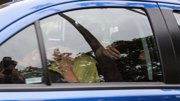 Alo Bridget Namoa leaves Silverwater Jail covered by her family on February 11, 2016.