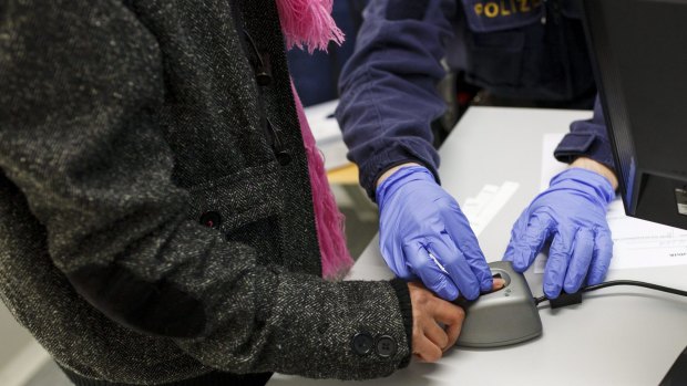 A migrant's fingerprints are scanned at the border crossing in Spielfeld, Austria.