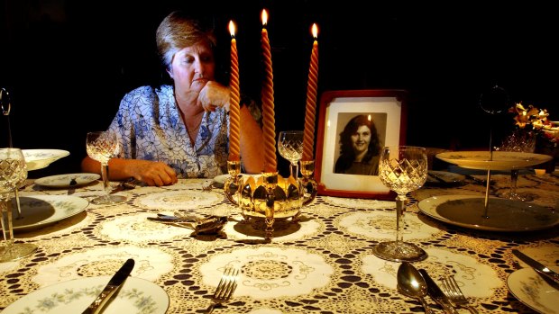 Trish Riggs' mother Carol Saxton at home in Queanbeyan in 2003. Her daughter made the tablecloth and Mrs Saxton always laid it out at Christmas. Mrs Saxton died in 2011, not knowing what happened to her daughter.
