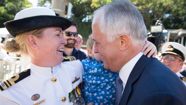 Prime Minister Malcolm Turnbull gets a hug and kiss from Lt Commander Tina Brown's son, Mason, before she departs for an extended tour in the Gulf on the HMAS Darwin.