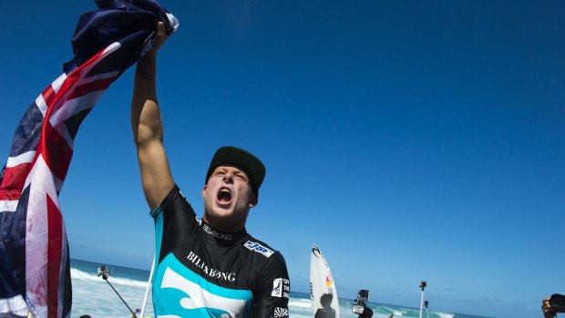 Top once again: Mick Fanning celebrates claiming is third world title.