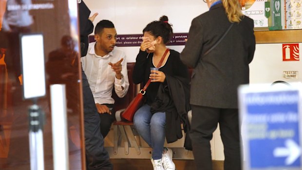 A relative of the victims of the EgyptAir flight 804 wipes her tears as she is comforted at Charles de Gaulle Airport outside Paris.