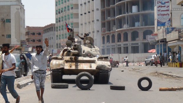 Militiamen loyal to Yemen's President take positions in Aden.
