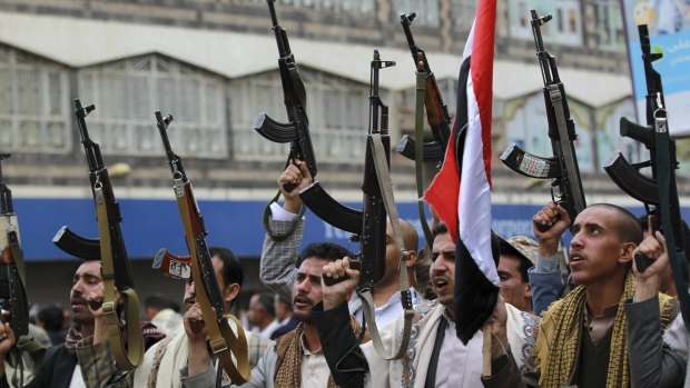 Shiite rebels, known as Houthis, hold up their weapons to protest against Saudi-led air strikes in Sanaa, Yemen.
