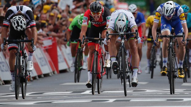 Sagan, second right, pushes over the finish line ahead of second place Australia's Michael Matthews, left, third place Ireland's Daniel Martin, right, and Belgium's Greg van Avermaet, second left, to win.
