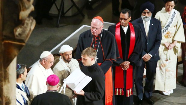 Pope Francis, second left, reads a passage during a multi-religious service at the 9/11 Museum on Friday.