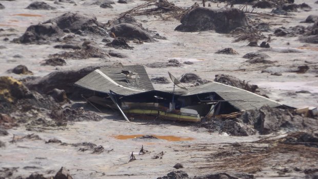 A farmhouse buried in mud in Bento Rodrigues after the BHP-Vale Samarco dam failure. 