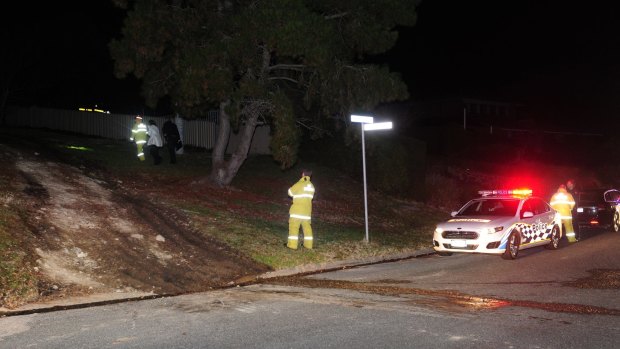 Emergency services attend a car fire off Hawkesbury Crescent in Farrer Thursday night. Police believe the car was used in the robbery.