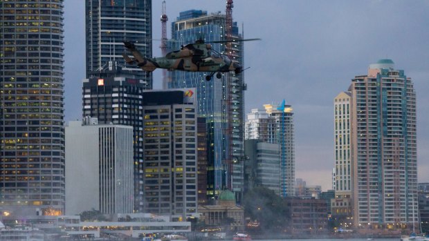A Tiger attack helicopter goes through its paces in inner Brisbane.