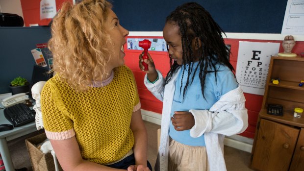 Carlton Primary School has used donations to create a new preschool program. "Doctor" Aisha looks at teacher Sarah Watson's sore throat.