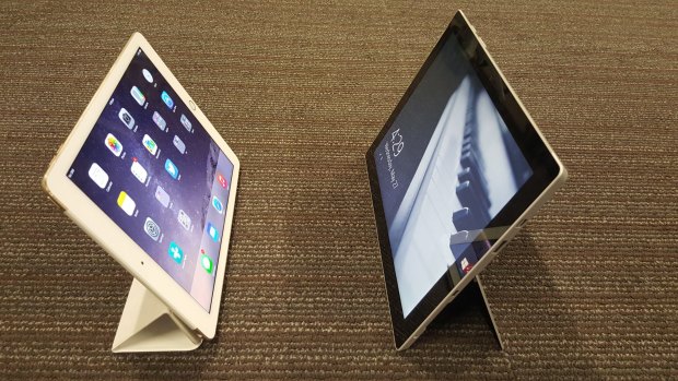 The Surface 3's built-in stand (right) is sturdier than the iPad's signature fold-up stand.