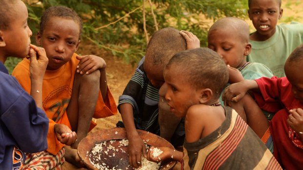 New child asylum seekers into Kenya Dadaab refugee camp from Somalia eat their first meal in days.