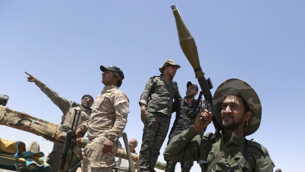 Fighters from the Iran-backed Badr Organisation militia at the front line in Kessarrat, 70 kilometres north-west of Baghdad. The US State Department has argued that unless the Pentagon backs Iraq's government, Iranian proxies will fill the vacuum.