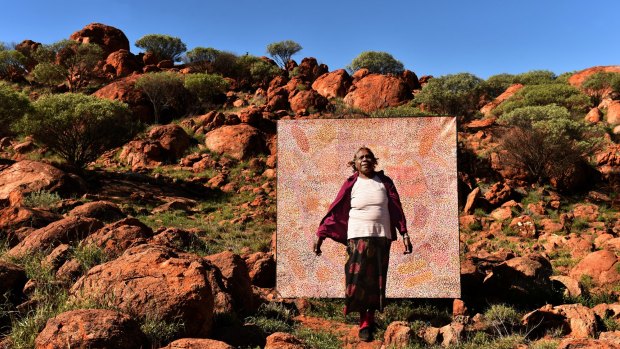 Ngupulya Pumani with one of her art works.
