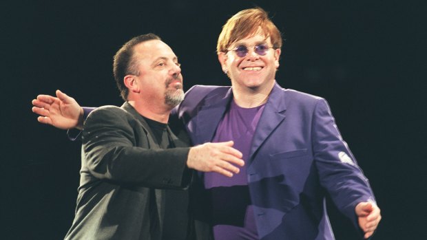 Billy Joel, left, and Elton John  on stage.
