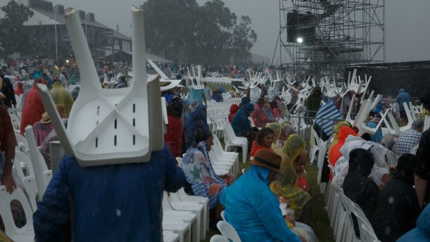 Concert-goers used the lawn chairs as shields against the hailstones. 