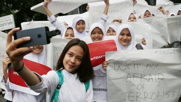 An Indonesian student takes a selfie during a rally for solidarity on Friday following the attacks in Jakarta on Thursday.
