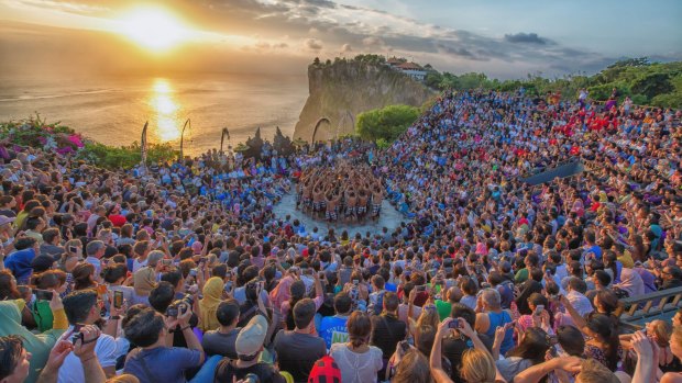 Peaceful? The sun sets on Uluwatu temple as locals perform at traditional Balinese Kecak dance.