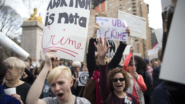 Demonstators at  rally in New York on Thursday protest against Republican presidential candidate Donald Trump's remarks about women and abortion. 
