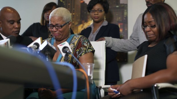 Sandra Bland's oldest sister Shante Needham, centre, becomes emotional as she tries to answer a question from a reporter at a news conference about her sister's death.