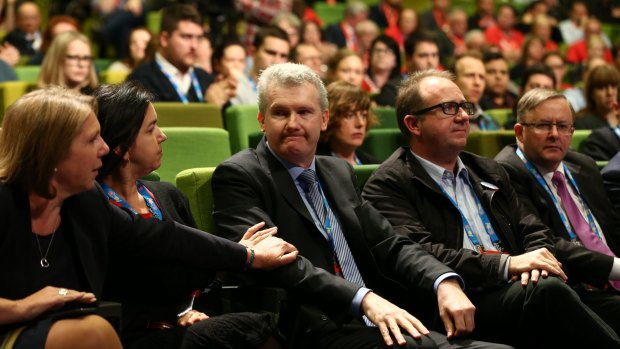 An emotional Tony Burke is comforted by colleagues after sharing stories from his time as immigration minister.