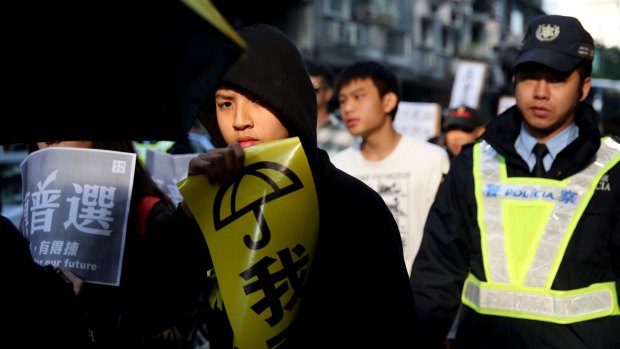 A protester holds a sign during a pro-democracy protest in Macau on Saturday.