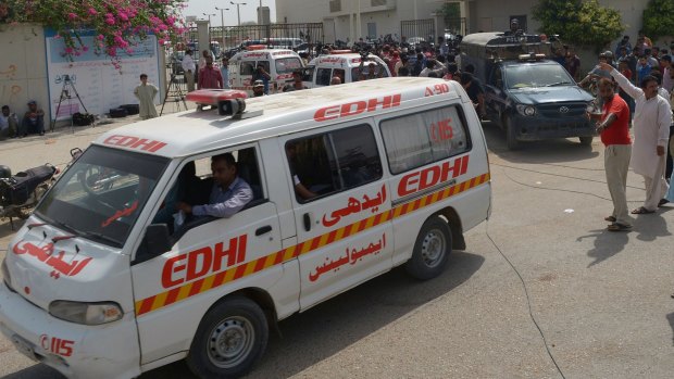 Ambulances transport the bodies of Shiite Muslims killed in a massacre by Islamic State gunmen in Karachi.