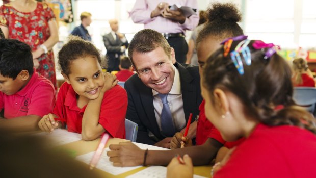 NSW Premier Mike Baird visits Queanbeyan South Public School on  Tuesday. His government plans to privatise the state's "polls and wires" if it wins this month's state election.