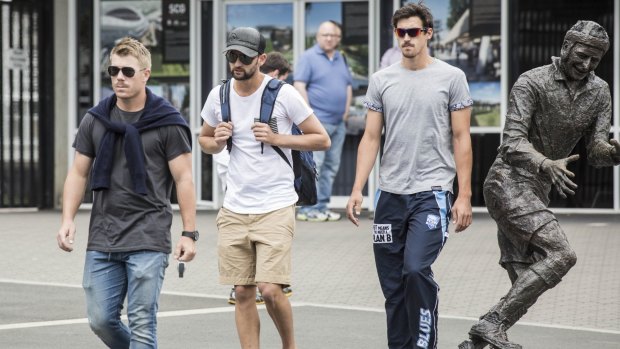 NSW cricketers David Warner, Nathan Lyon and Mitchell Starc leave the SCG after a squad meeting following the Phillip Hughes accident.