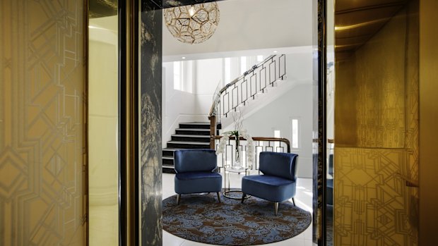 The blink-and-you'll-miss-it entrance on Queen Street leads into a small, tiled vestibule area with twin gold chandeliers.