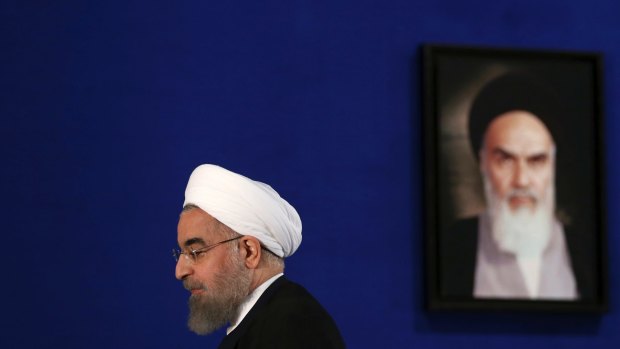 Iranian President Hassan Rouhani with a portrait of the Islamic Republic's founder and first supreme leader, Ayatollah Ruhollah Khomeini.
