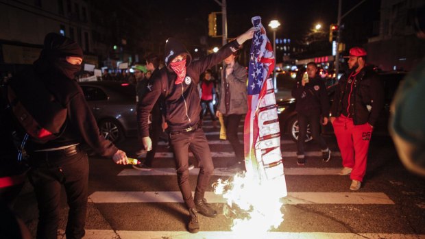 A demonstrator burns an American flag during a protest in New York City.